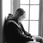 man-wearing-mask-sitting-near-window-panel-1046567 (1)small